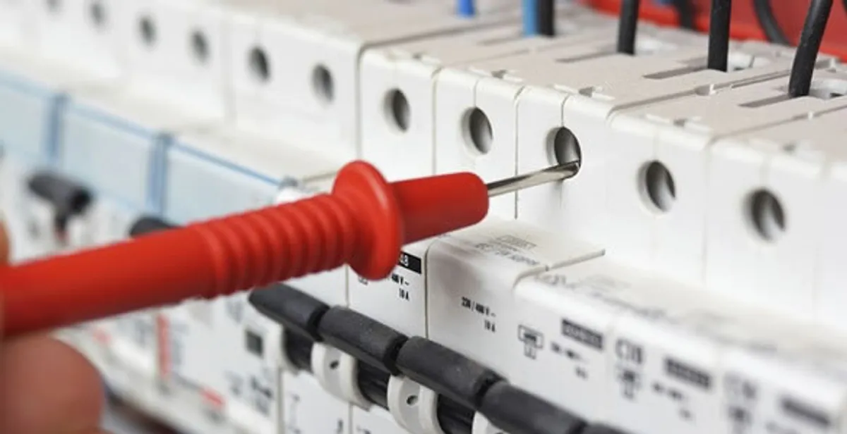 Electrical contractor testing circuit breakers during electrical repair in West Newton, MA