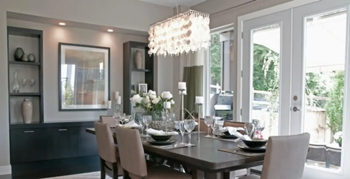 Elegant dining room chandelier installation above table in Waltham, MA