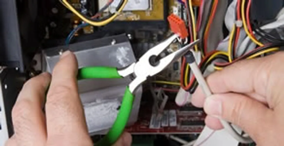 Licensed electrical contractor performing electrical repair with tools in Newton Lower Falls, MA